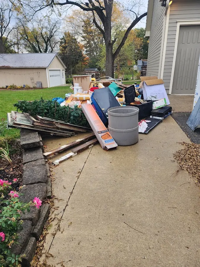 Dumpster being loaded with debris for Commercial Dumpster Rental in Helena Valley Northwest